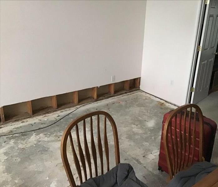 A room with the carpet removed and a flood cut with equipment placed