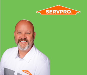 A man in front of  SERVPRO logo