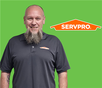 a man in front of a servpro background