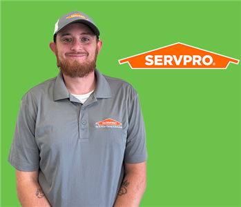 man in front of servpro logo