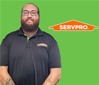 a man in front of a servpro background