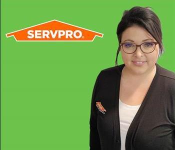 woman in front of SERVPRO logo