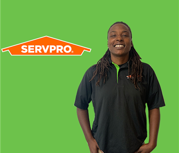 person in front of SERVPRO logo