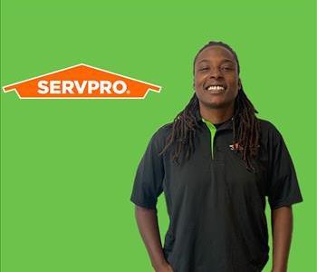 person in front of SERVPRO logo