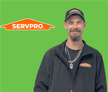 man in front of servpro logo